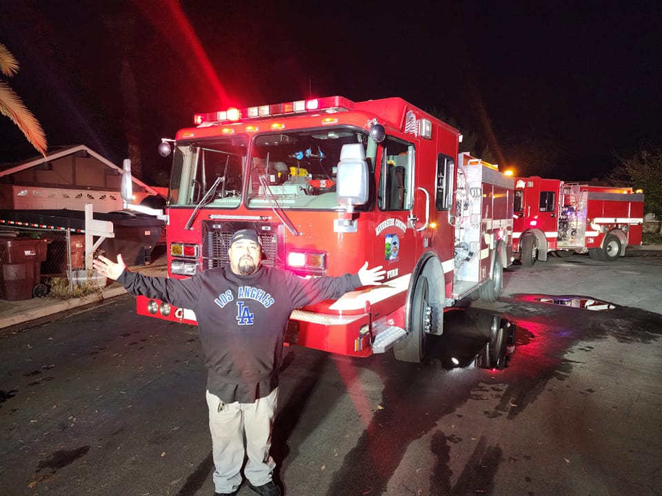 Jay Vee News in front of fire engine